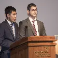 man speaking at podium