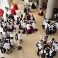 An aerial photo of a group of white coat clad students serving themselves food